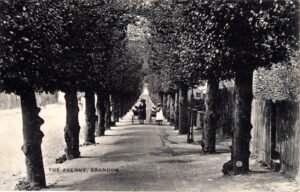 View along the avenue. Woman and girl pushing perambulators
