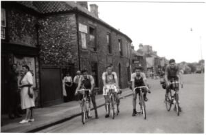 Miss Dann's shop and cyclists ni 1953